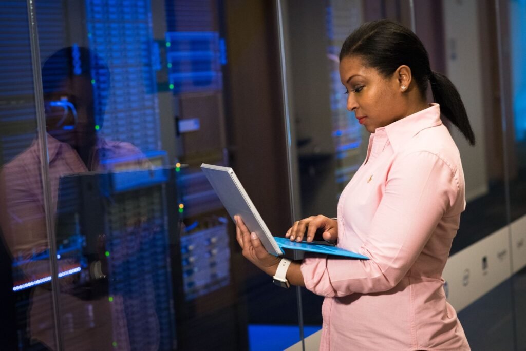 IT technician checking business network equipment for performance and reliability